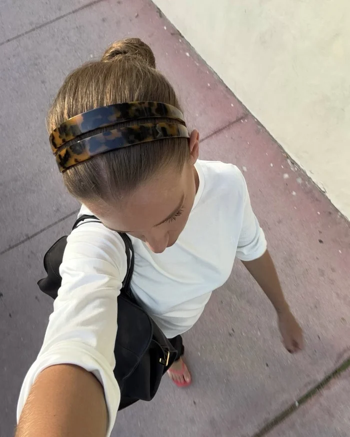 Top-down selfie of a slicked-back bun with a double tortoiseshell headband